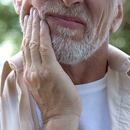 Closeup of man experiencing jaw pain