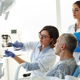 Dentist reviewing X-ray with patient